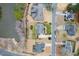 An aerial view of a neighborhood showcasing well-maintained homes with manicured lawns and landscaping along a peaceful body of water at 2639 Bowden Dr, Creedmoor, NC 27522