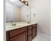 Bathroom vanity featuring double sinks and a large mirror at 2639 Bowden Dr, Creedmoor, NC 27522
