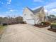 Spacious driveway leading to a home with neutral and brick siding, surrounded by greenery at 2639 Bowden Dr, Creedmoor, NC 27522