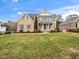 Charming brick two-story home features a well-manicured lawn, shuttered windows, a covered porch and inviting curb appeal at 2639 Bowden Dr, Creedmoor, NC 27522