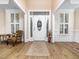 Elegant foyer with hardwood floors, decorative door with sidelights, and neutral wall colors at 2639 Bowden Dr, Creedmoor, NC 27522