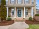 Charming front porch with rocking chairs, columns, and beautifully landscaped surroundings at 2639 Bowden Dr, Creedmoor, NC 27522