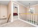 Spacious upstairs hallway with carpet and a decorative light fixture at 2639 Bowden Dr, Creedmoor, NC 27522