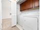 Convenient laundry room with washer, dryer, and built-in storage cabinets at 2639 Bowden Dr, Creedmoor, NC 27522