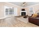 Cozy living room with a fireplace, ceiling fan, and sliding glass doors to the outside deck at 2639 Bowden Dr, Creedmoor, NC 27522