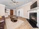 Open-concept living room featuring a fireplace, wood floors, and access to the outdoor area at 2639 Bowden Dr, Creedmoor, NC 27522