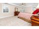 A main bedroom with decorative tray ceiling, fan, and two side tables with lamps at 2639 Bowden Dr, Creedmoor, NC 27522