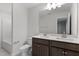 Bathroom featuring vanity with dual sinks, dark wood cabinets and a large mirror at 3016 Dog Rose Dr # 303, Durham, NC 27703