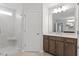 Well-lit bathroom featuring a vanity with dark wood cabinets, and a glass-enclosed shower at 3016 Dog Rose Dr # 303, Durham, NC 27703
