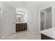 Bright bathroom featuring a double vanity, large mirror and doorway to a walk-in closet at 3016 Dog Rose Dr # 303, Durham, NC 27703
