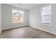 Bright bedroom with hardwood floors and two large windows overlooking the yard at 3016 Dog Rose Dr # 303, Durham, NC 27703