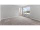 Neutral bedroom featuring plush carpet flooring and a window providing ample natural light at 3016 Dog Rose Dr # 303, Durham, NC 27703