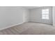 Well-lit bedroom with neutral carpet and a closet at 3016 Dog Rose Dr # 303, Durham, NC 27703