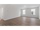 Bonus room with light hardwood-style flooring and natural light from two windows at 3016 Dog Rose Dr # 303, Durham, NC 27703