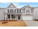 Charming two-story home features a welcoming front porch and attached two-car garage at 3016 Dog Rose Dr # 303, Durham, NC 27703