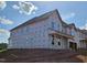 New construction home exterior featuring multiple windows and a covered porch at 3016 Dog Rose Dr # 303, Durham, NC 27703