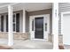 Close-up of a welcoming front entrance with stone accents and a black front door at 3016 Dog Rose Dr # 303, Durham, NC 27703