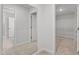 Bright hallway featuring neutral paint, carpet flooring, and doorways leading to other rooms at 3016 Dog Rose Dr # 303, Durham, NC 27703
