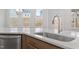 Kitchen island with stainless steel sink and faucet overlooking backyard at 3016 Dog Rose Dr # 303, Durham, NC 27703
