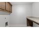 Laundry room with granite countertop, wooden cabinets, sink, tile flooring, and grey walls at 3016 Dog Rose Dr # 303, Durham, NC 27703