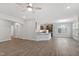 Open-concept living space featuring wood floors, archway, and a view of the kitchen with stainless steel appliances at 3016 Dog Rose Dr # 303, Durham, NC 27703