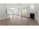 Open concept living room featuring hardwood floors, fireplace, and view of the kitchen at 3016 Dog Rose Dr # 303, Durham, NC 27703