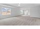 Bright main bedroom featuring neutral walls and plush carpet flooring and three windows at 3016 Dog Rose Dr # 303, Durham, NC 27703