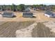 An aerial shot of multiple homes in a spacious layout with large yards and gravel driveways at 3131 Pilson Rd, Cameron, NC 28326