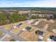 An elevated angle of a new home community featuring expansive lots, trees, and nearby lakes at 3131 Pilson Rd, Cameron, NC 28326