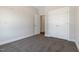 This bedroom features neutral walls, carpeting, a closet with double doors, and an entry door at 3131 Pilson Rd, Cameron, NC 28326
