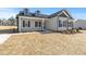 Classic exterior with light gray siding, dormer windows, a covered porch, and dark trim at 3131 Pilson Rd, Cameron, NC 28326
