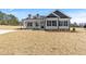 New construction home with black trimmed windows, dormers, and a well-maintained lawn at 3131 Pilson Rd, Cameron, NC 28326