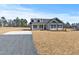 Inviting exterior view with a gravel drive leading to a light gray house with black shutters at 3131 Pilson Rd, Cameron, NC 28326