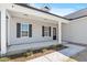 Charming covered front porch with black shutters and a welcoming entrance door at 3131 Pilson Rd, Cameron, NC 28326
