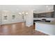 Open-concept kitchen flows into dining area, showcasing modern finishes and stainless steel appliances at 3131 Pilson Rd, Cameron, NC 28326