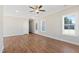 Bright, open living room featuring hardwood floors, neutral paint, and natural light from large windows at 3131 Pilson Rd, Cameron, NC 28326