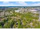 Aerial view of a condo complex surrounded by lush trees and nearby shopping centers at 32 Melstone Turn, Durham, NC 27707