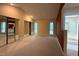 Large bedroom with mirrored closet doors and a view into ensuite bath at 32 Melstone Turn, Durham, NC 27707