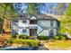 Inviting condo with well-maintained landscaping, red door, and second story balcony at 32 Melstone Turn, Durham, NC 27707