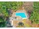 Aerial view of a community pool, surrounded by a fence and mature trees at 32 Melstone Turn, Durham, NC 27707