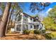 Condo building featuring large windows, manicured landscaping, and lots of trees at 32 Melstone Turn, Durham, NC 27707