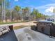 Outdoor patio area featuring a grill and backyard with a view of surrounding trees at 325 Azalea Gaze Dr, Youngsville, NC 27596