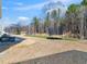 Large backyard featuring a grassy area, grill, and a wooded backdrop at 325 Azalea Gaze Dr, Youngsville, NC 27596