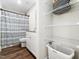 Bathroom featuring an open shelving unit for towels and a neutral patterned shower curtain at 325 Azalea Gaze Dr, Youngsville, NC 27596