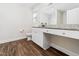 Bright bathroom with granite counters, white cabinets, wood look flooring and a built-in vanity area at 325 Azalea Gaze Dr, Youngsville, NC 27596