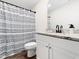 Clean bathroom with granite vanity, stylish faucet, and patterned shower curtain for modern comfort at 325 Azalea Gaze Dr, Youngsville, NC 27596