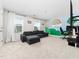 Spacious bonus room featuring carpet floors, natural light, and playful wall art at 325 Azalea Gaze Dr, Youngsville, NC 27596