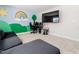 Inviting bonus room with playful mural, modern seating, and entertainment setup at 325 Azalea Gaze Dr, Youngsville, NC 27596