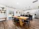 Open dining area featuring a long wooden table and kitchen island with modern bar stools at 325 Azalea Gaze Dr, Youngsville, NC 27596