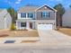 Charming home with a two-car garage, stone facade, and manicured landscaping at 325 Azalea Gaze Dr, Youngsville, NC 27596